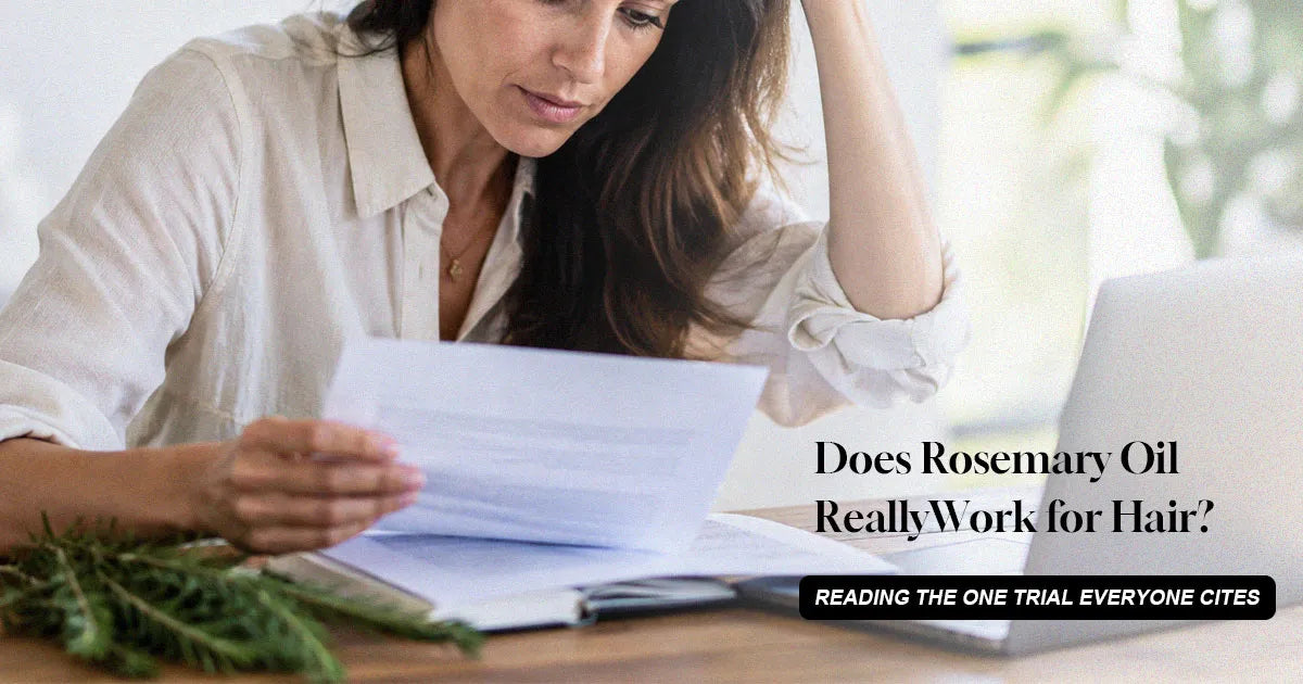 Woman reading research papers beside rosemary sprigs